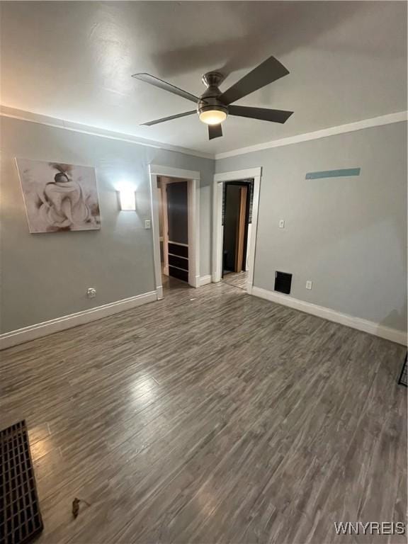 unfurnished bedroom featuring crown molding, ceiling fan, and dark hardwood / wood-style flooring