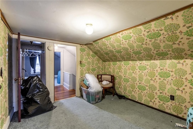 bonus room featuring lofted ceiling and carpet