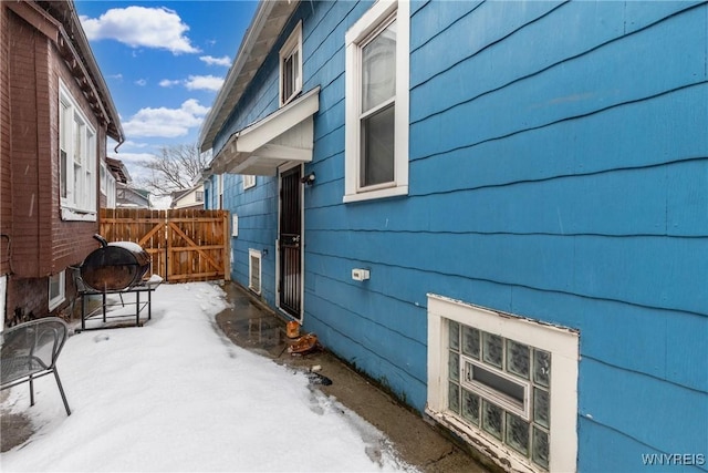 view of snowy exterior with an outdoor fire pit