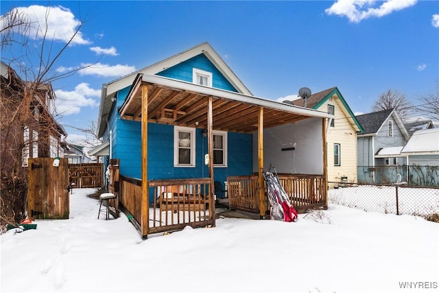 snow covered property featuring a porch