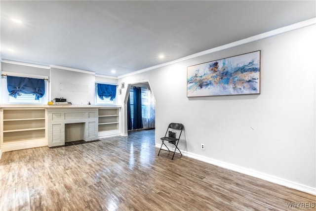 living room featuring ornamental molding and wood-type flooring