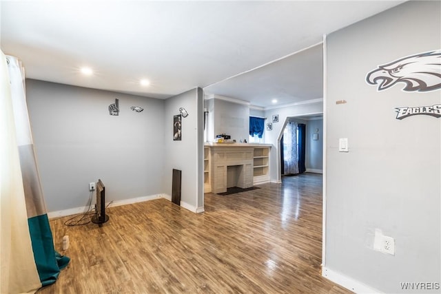 interior space with wood-type flooring and crown molding