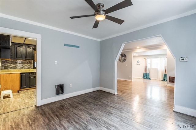 unfurnished living room with ceiling fan, ornamental molding, and light hardwood / wood-style flooring