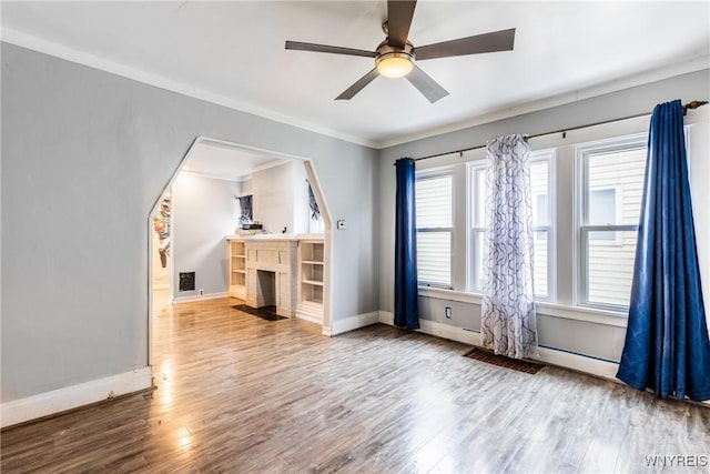 unfurnished bedroom featuring crown molding, hardwood / wood-style flooring, and ceiling fan