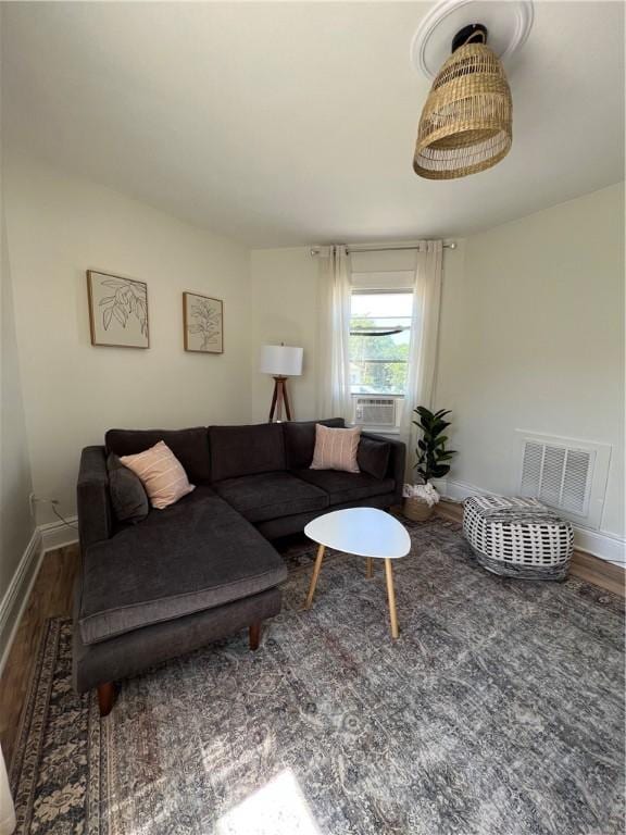 living room featuring cooling unit and dark wood-type flooring