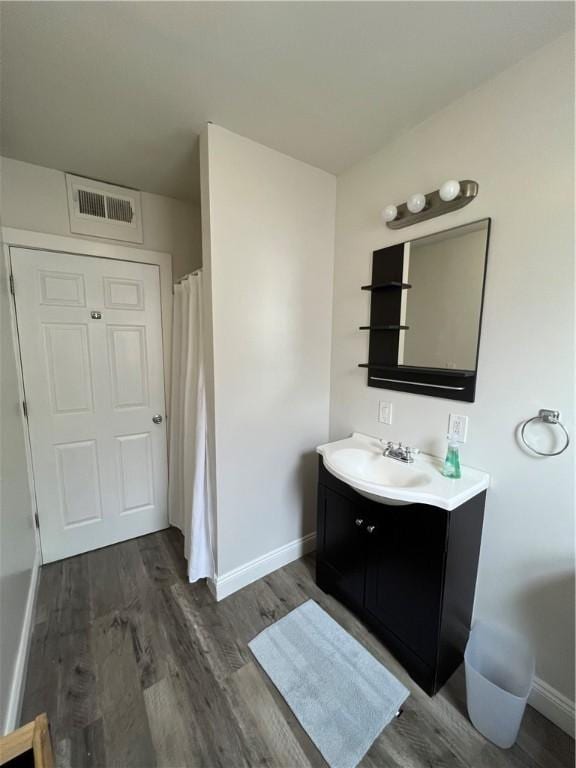 bathroom featuring wood-type flooring and vanity