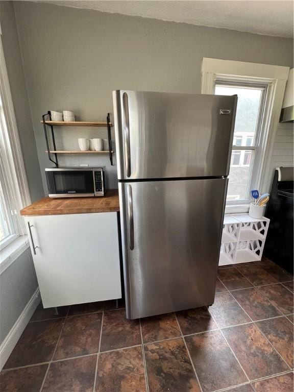 kitchen featuring wood counters and stainless steel appliances