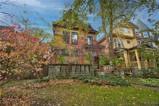 rear view of property featuring a yard