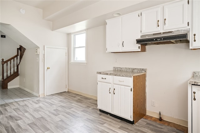 kitchen with white cabinets and light wood-type flooring