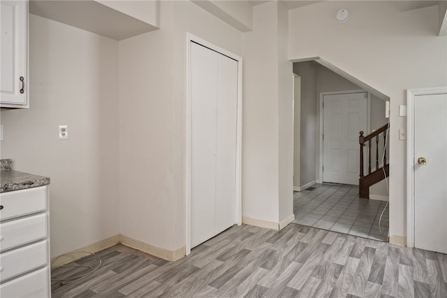 kitchen featuring light hardwood / wood-style floors and white cabinetry