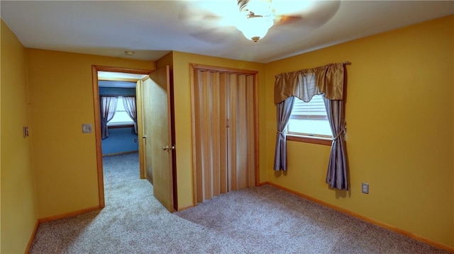 unfurnished room with light colored carpet and a healthy amount of sunlight