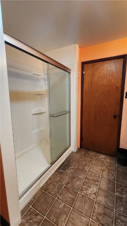 bathroom with tile patterned floors and a shower with shower door