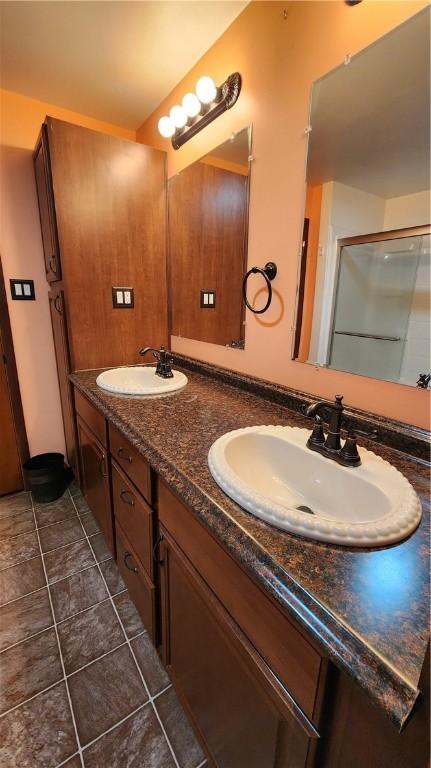 bathroom featuring tile patterned flooring and vanity