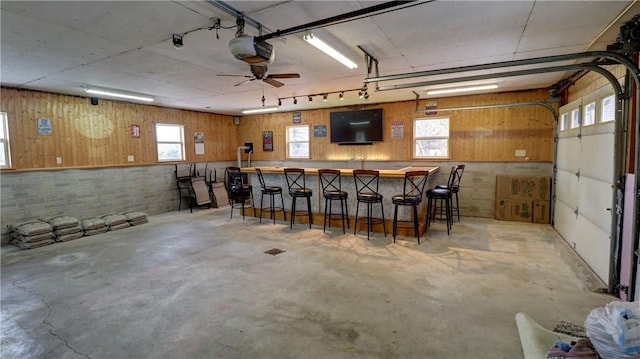 garage with ceiling fan and a garage door opener