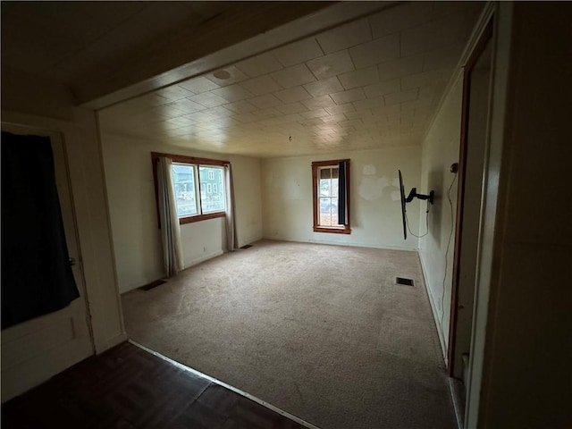 carpeted spare room with a healthy amount of sunlight