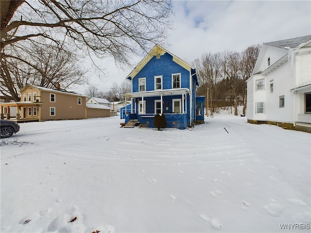 snow covered property featuring a porch