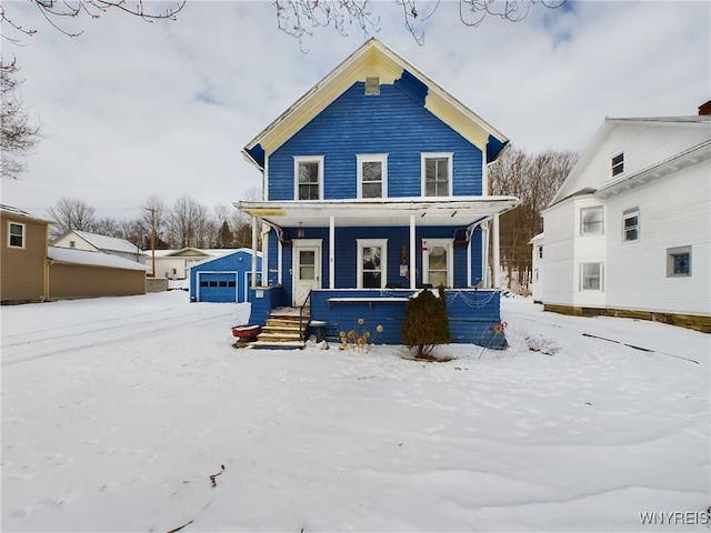 view of front of home featuring an outbuilding, a garage, and covered porch