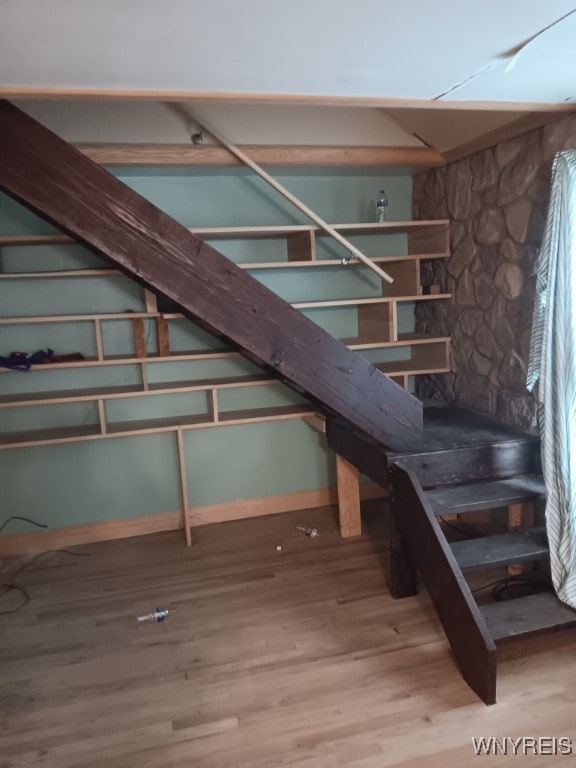 stairway with hardwood / wood-style floors