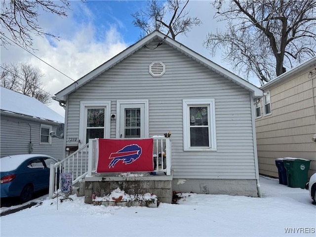 view of snow covered rear of property