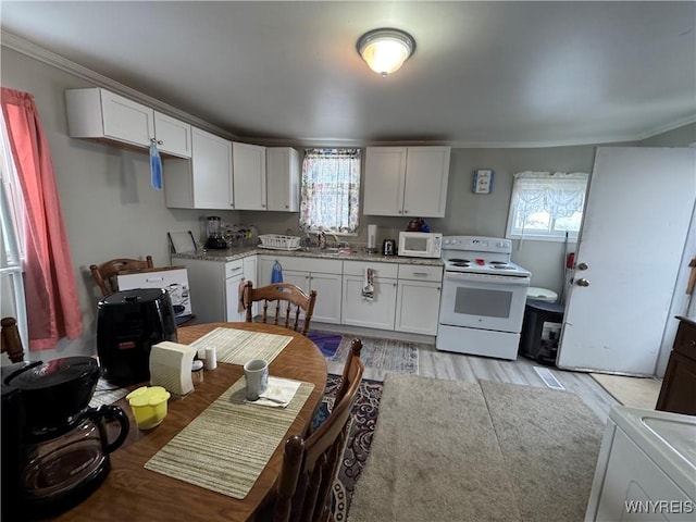 kitchen featuring white appliances, light hardwood / wood-style flooring, white cabinetry, and sink