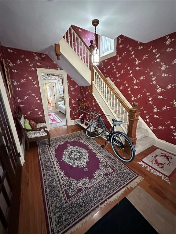 stairs featuring hardwood / wood-style flooring and lofted ceiling