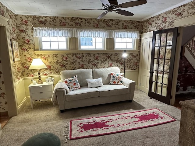 living room with light carpet, ceiling fan, and ornamental molding