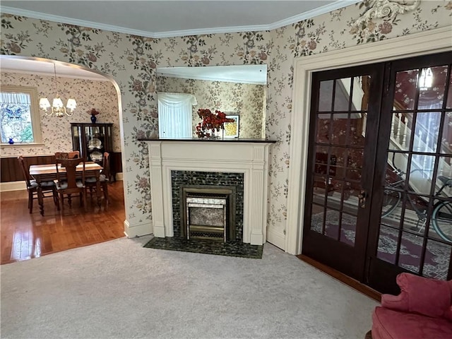 living room featuring a notable chandelier, wood-type flooring, and ornamental molding