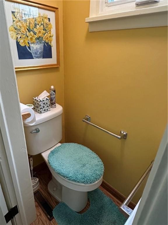 bathroom featuring hardwood / wood-style floors and toilet