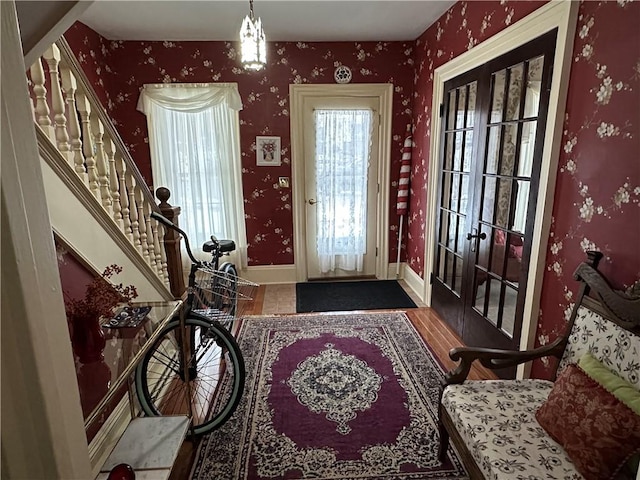 foyer entrance featuring dark hardwood / wood-style flooring and french doors