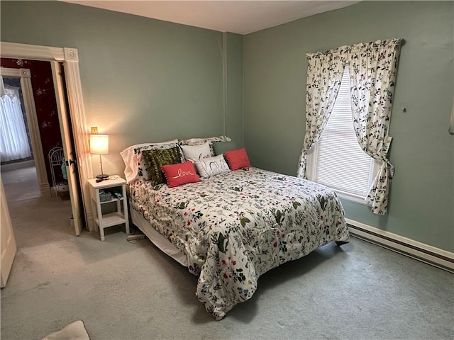 carpeted bedroom with a baseboard heating unit