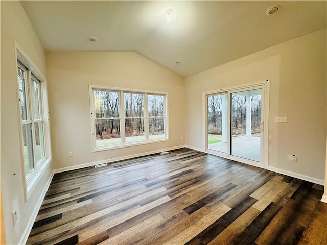 unfurnished room featuring dark hardwood / wood-style flooring and vaulted ceiling