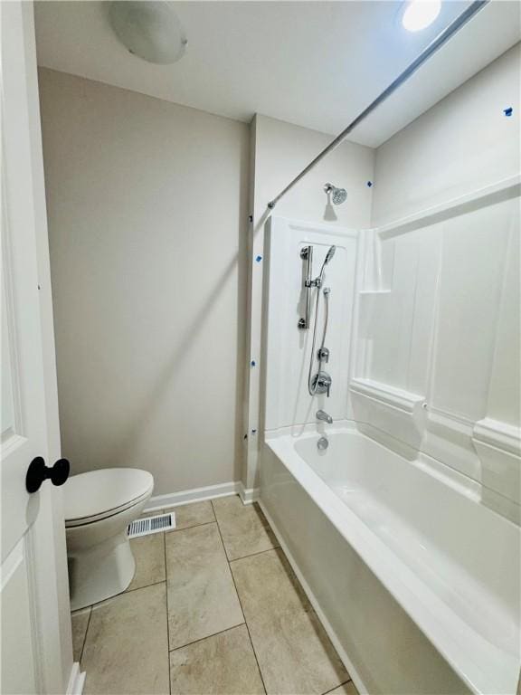 bathroom featuring tile patterned flooring, toilet, and shower / bath combination