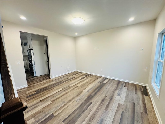 empty room with hardwood / wood-style flooring