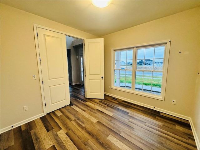 unfurnished room with hardwood / wood-style flooring