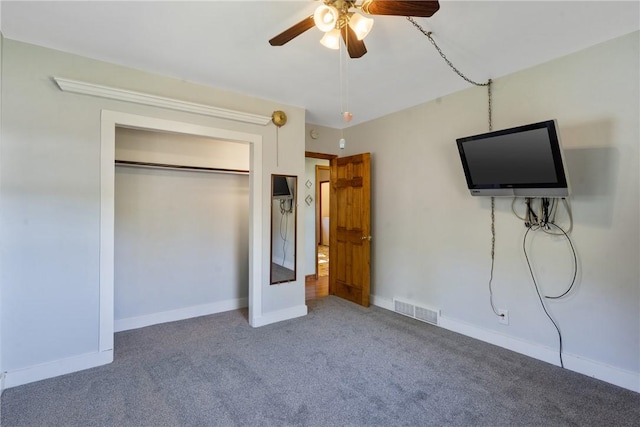 unfurnished bedroom with carpet, a closet, and ceiling fan