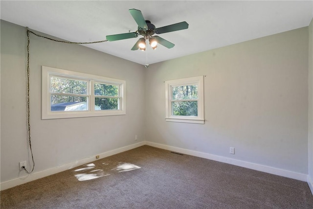 unfurnished room featuring ceiling fan and carpet