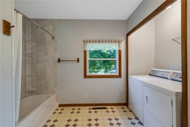 bathroom featuring tiled shower / bath combo and washing machine and clothes dryer