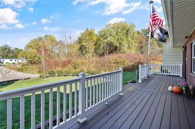 wooden terrace featuring a lawn