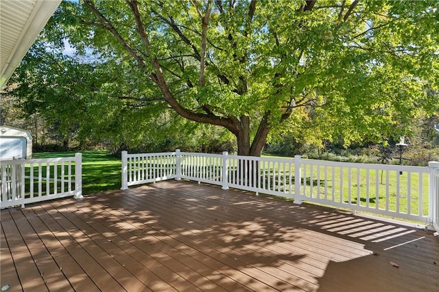 wooden deck featuring a yard