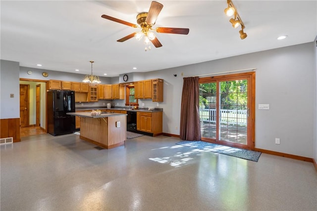 kitchen featuring a breakfast bar, a center island, black appliances, ceiling fan with notable chandelier, and decorative light fixtures