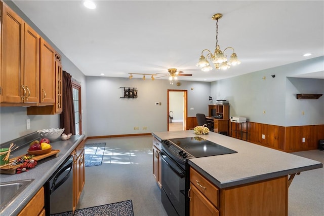 kitchen featuring ceiling fan with notable chandelier, decorative light fixtures, a kitchen island, and black appliances