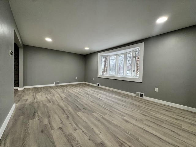 empty room with light hardwood / wood-style floors