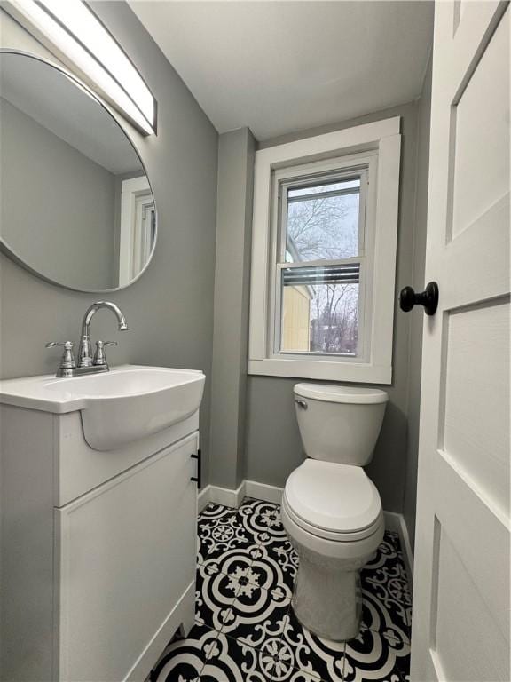 bathroom featuring tile patterned floors, vanity, and toilet