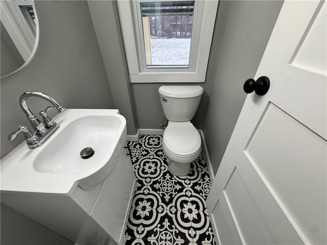 bathroom featuring tile patterned flooring, toilet, and sink