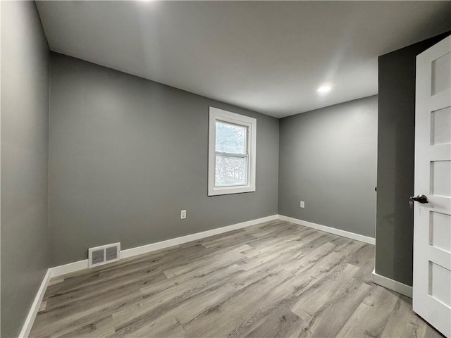 empty room with light hardwood / wood-style flooring