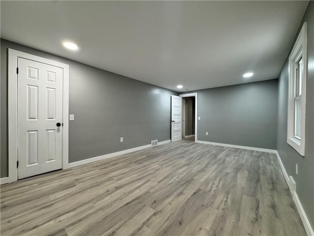 spare room with light hardwood / wood-style flooring