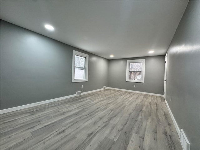 empty room with light hardwood / wood-style floors