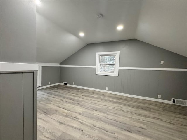 bonus room featuring light hardwood / wood-style flooring and lofted ceiling