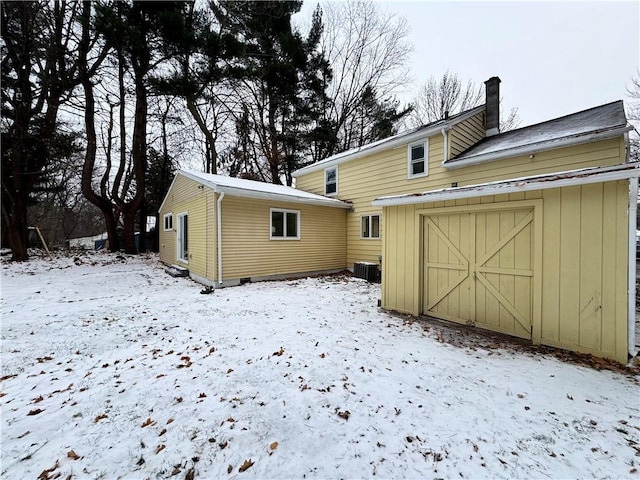 snow covered house with cooling unit