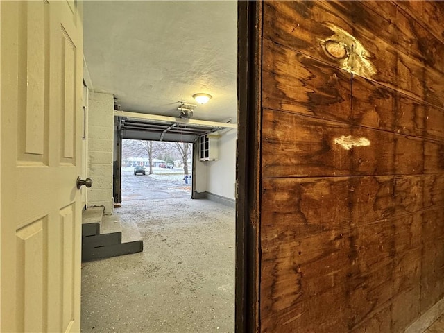 hall featuring a textured ceiling